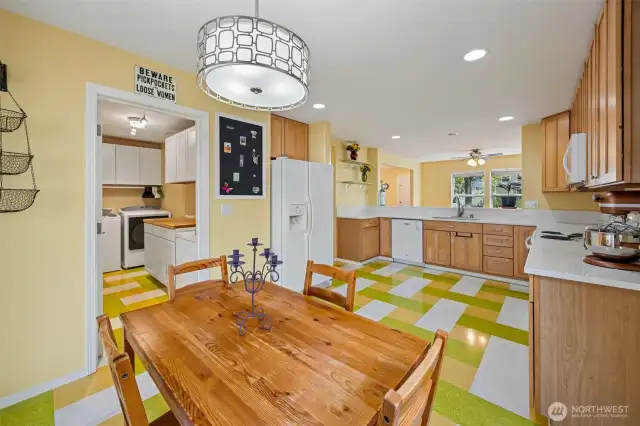 Personality packed vinyl flooring.  Additional pantry storage off laundry room which leads to the garage.