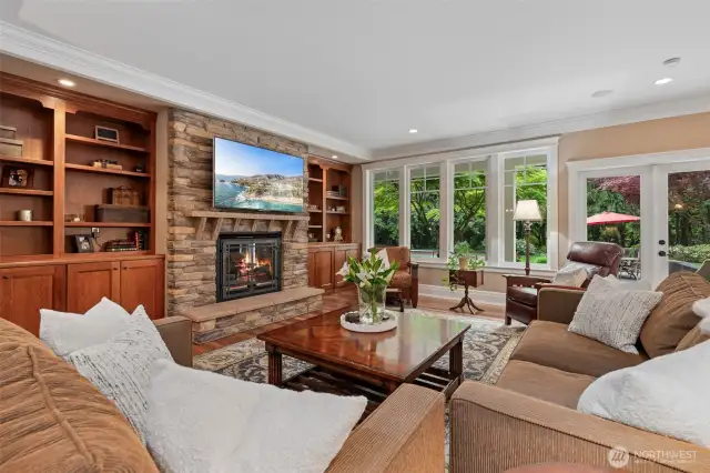 Formal Living Room w/ built-ins and custom stone gas fireplace.
