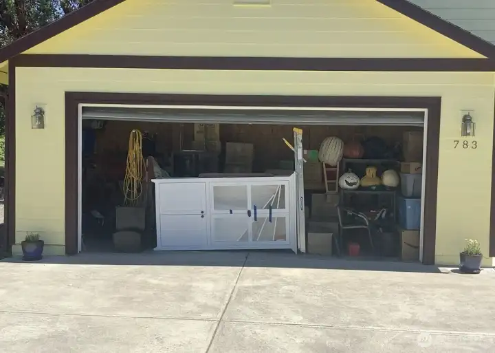 Garage Conversion has a false wall in back, accessed from inside the home as a separate Multi-USE Space.  The remaining garage area you see here is currently used for storage only. (No room for parking a vehicle however if the future buyer prefers a garage over extra interior square footage then the dividing wall can be removed and the garage be in full use again at buyers discretion.  Off street parking available in this private and dedicated driveway which is only used for this house.