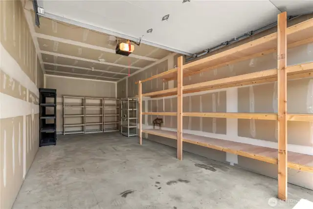 Spacious garage with built in shelving and storage potential - perfect for a boat