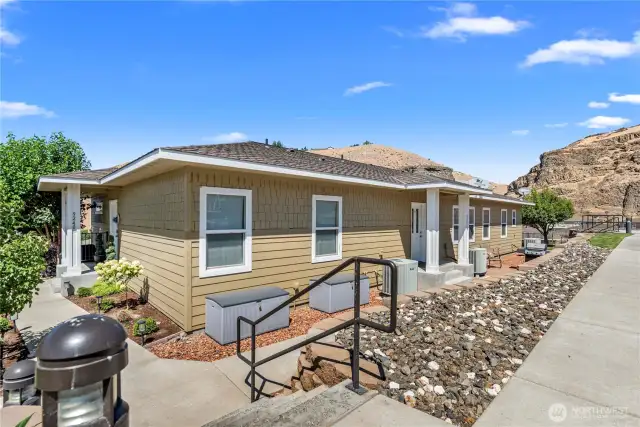 Front building elevation with stylish architectural lines and private entrance