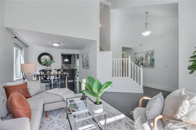 Formal living room next to dining room and stairs leading to 2nd floor