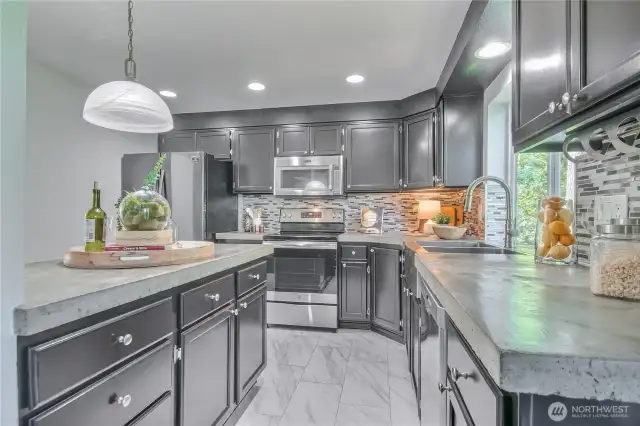 Remodeled kitchen with tile backsplash and concrete countertops