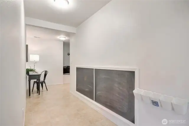 Hallway to rec room with chalk wall