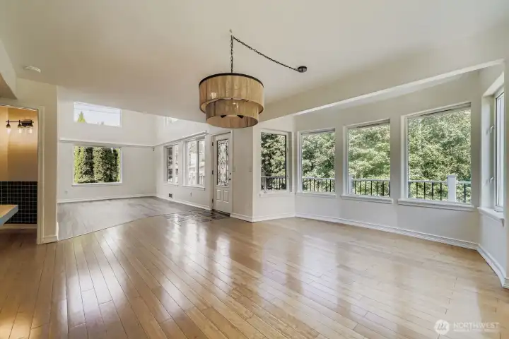 Dining room with walls of windows saturated in light