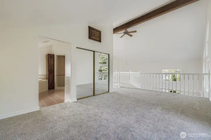 Primary suite and balcony with windows overlooking the trees or river views