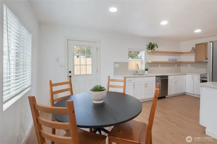 Dining space facing kitchen and back door