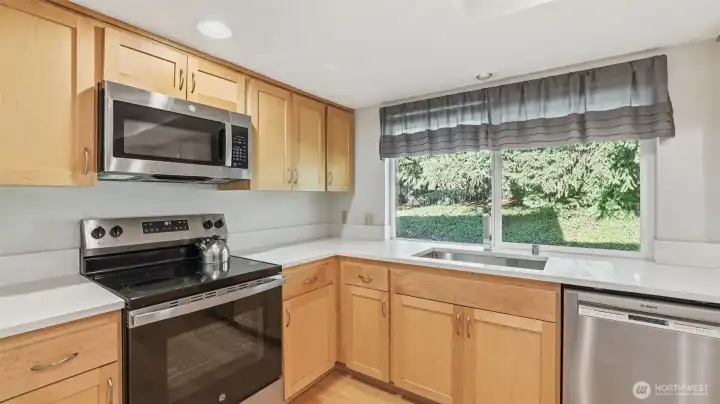Views to the private and tree-lined backyard make this kitchen window picture perfect!