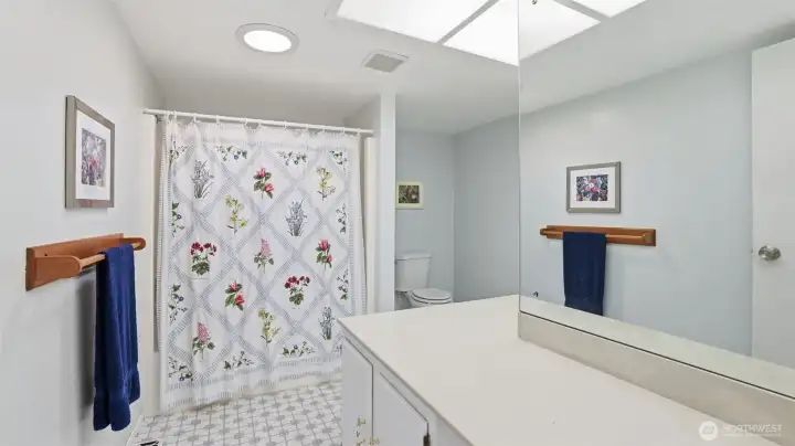 This upstairs full guest bathroom is huge and offers plenty of counter space!