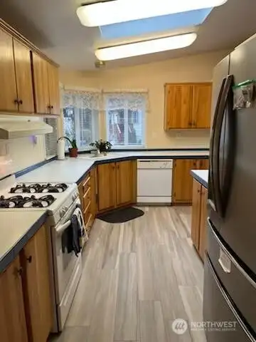 Galley Kitchen with nice SS Refrigerator and Skylight