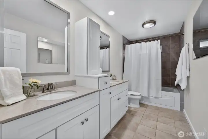 Updated main level bathroom with so much storage, new tub, new tile surround.