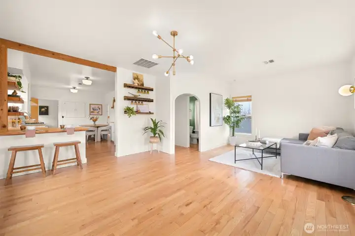 Enter to a large living room open to the kitchen, with ample space to add a full size dining table underneath the chandelier if desired.