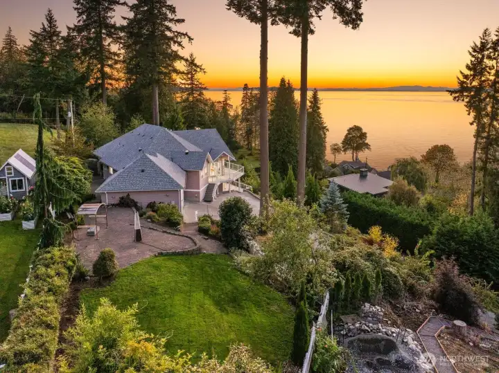 Sweeping western exposure bathes the terraced yard and garden paths in golden light, as the bay puts on a show for you.