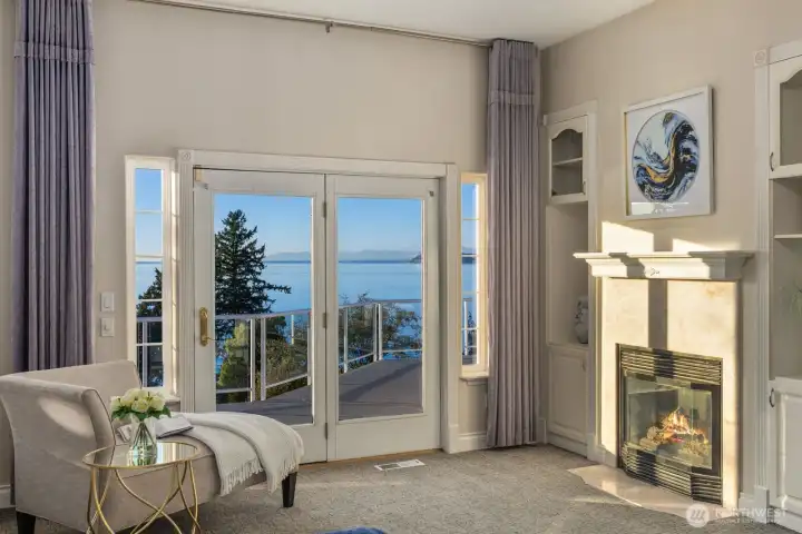 Natural light floods this sitting area where warmth meets tranquility. Cozy up by the gas fireplace or savor sunset views from your private balcony overlooking the bay.