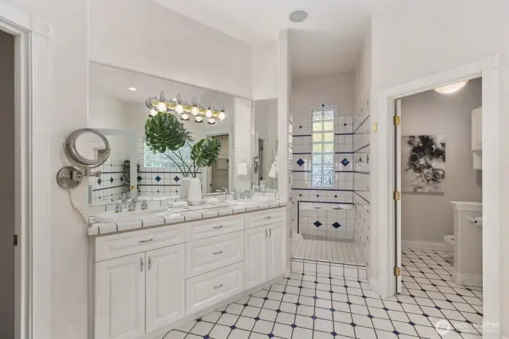 Spa-inspired bath with jet tub, shower, and dual vanities.