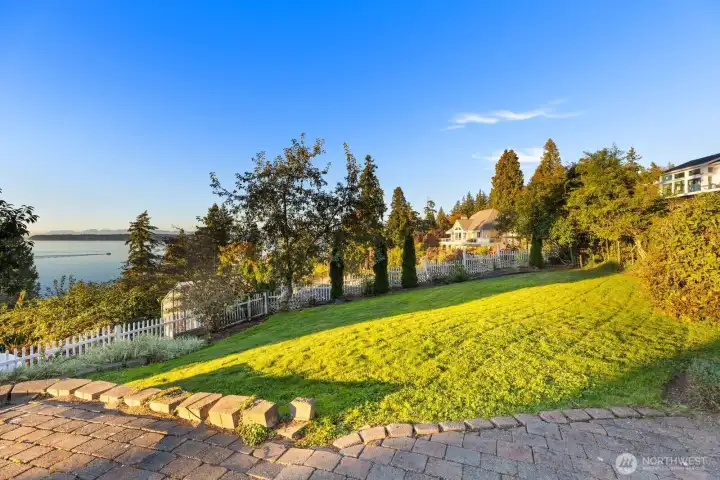 Mature apple and rare pear-apple trees add timeless charm and edible beauty to the garden landscape.