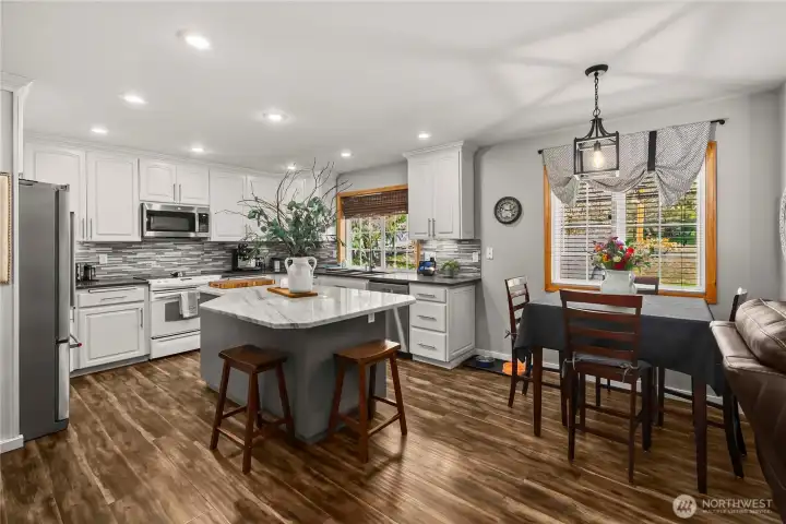 This kitchen is the perfect gathering place with a breakfast nook and counter seating.