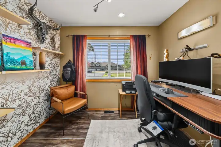 Main floor office with closet storage and hot/cold plumbing offers flexible potential for a wet bar, coffee station, salon, or creative workspace setup.
