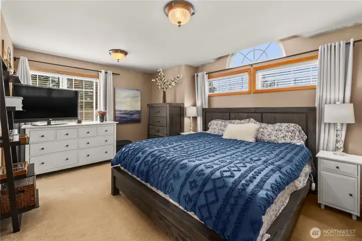 Spacious primary suite easily fits a king-sized bed with room for additional furniture and seating.