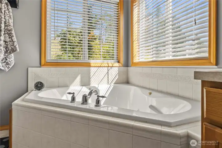 A jetted tub creates the perfect spot to unwind and ease into relaxation after a long day.