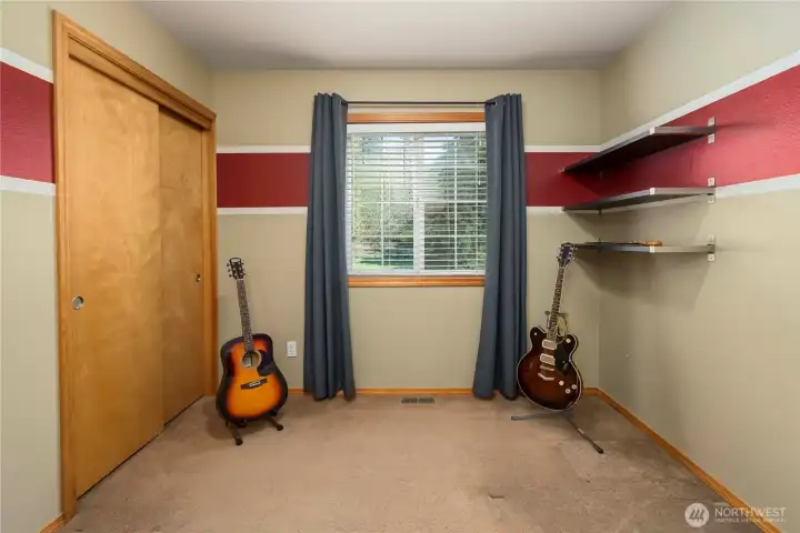 Bedroom four offers character with accent walls and a nice view of the backyard.