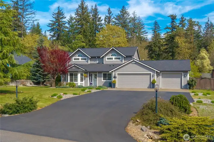 Tucked away at the end of a long driveway with space for numerous vehicles, this home is framed by mature trees that create a private, peaceful setting.