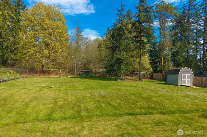 A generously sized fenced yard provides the perfect setting for outdoor activities, pets, and entertaining.