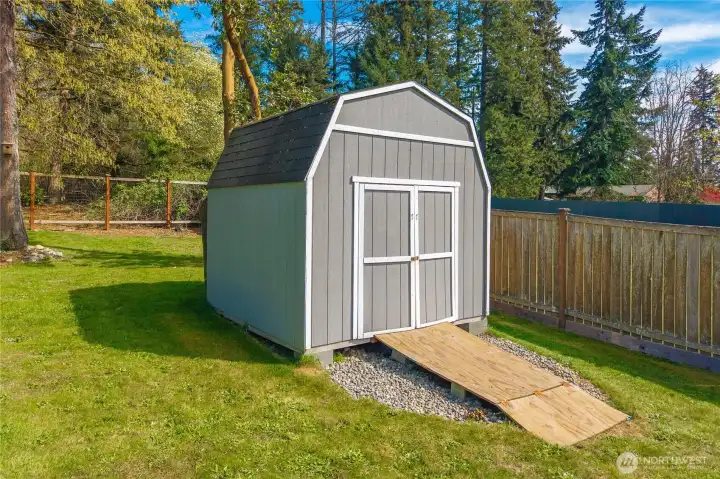 The shed keeps lawn and garden equipment neatly organized and easily accessible.