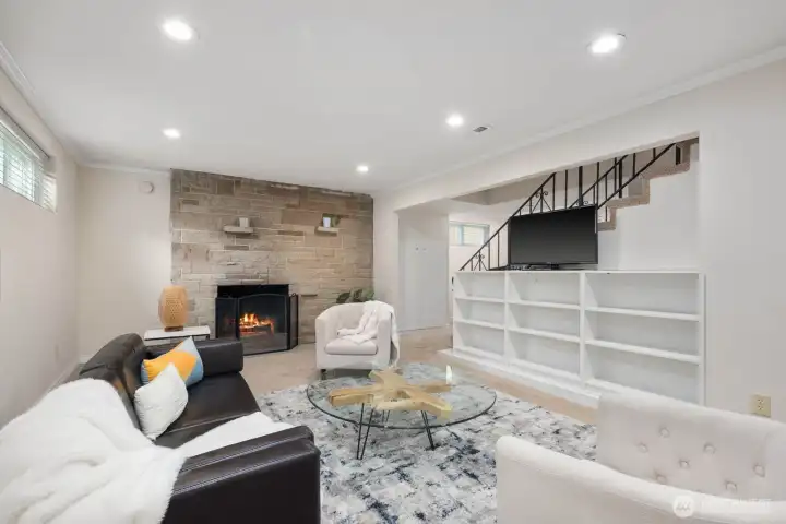 Downstairs family room with a cozy fireplace, built ins and plenty of room to relax and entertain