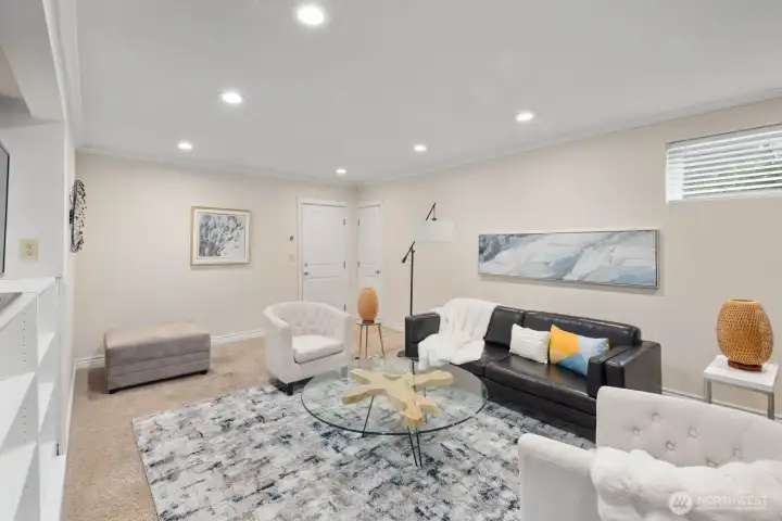 Downstairs family room with a cozy fireplace, built ins and plenty of room to relax and entertain