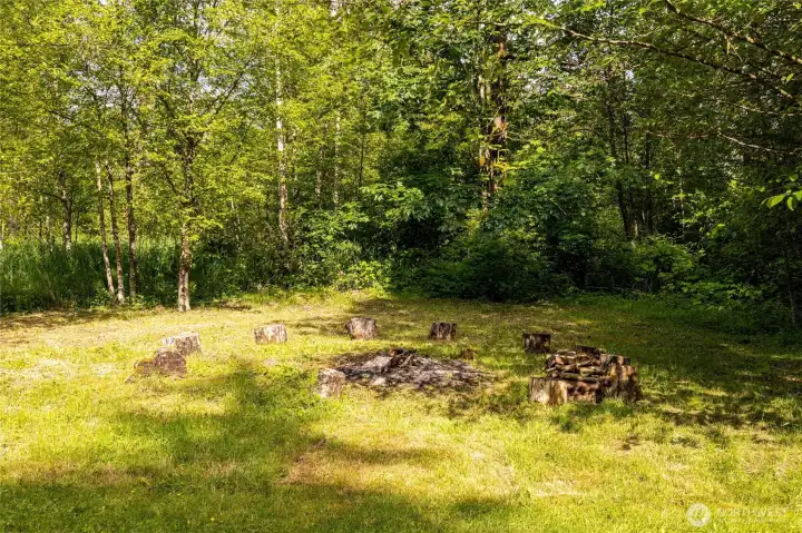 Peaceful outdoor gathering space surrounded by mature trees and nature