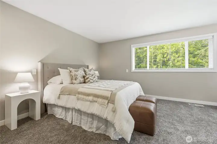 Spacious bedroom with peaceful wooded views
