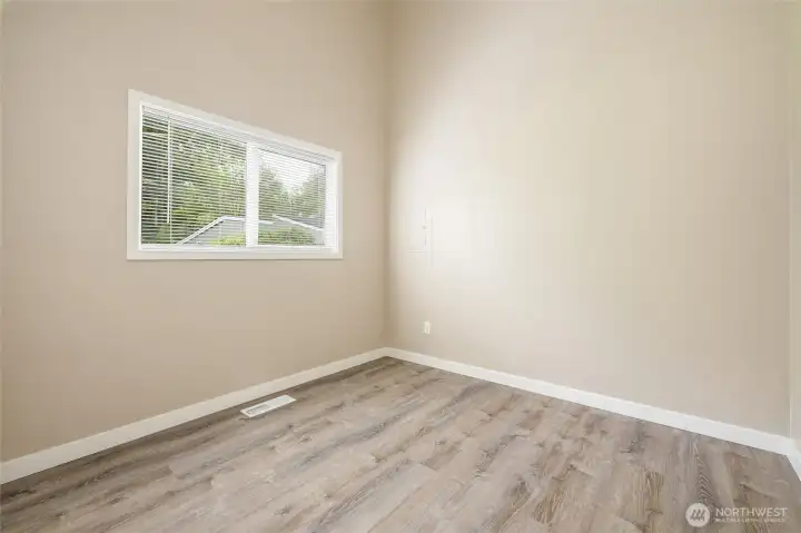 Additional bedroom with updated flooring and neutral finishes