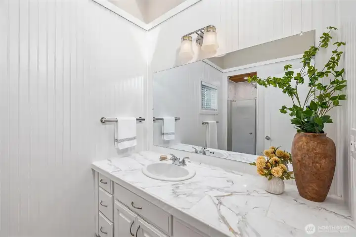 Clean, updated bathroom with bright finishes