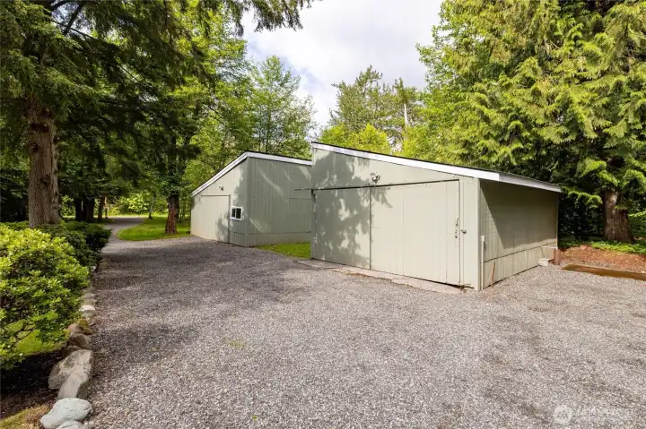 Detached outbuilding provides flexible parking, storage, or workshop space