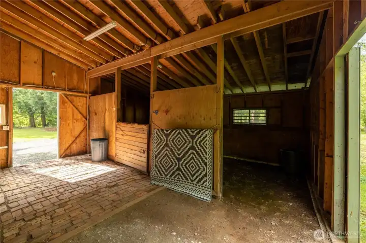 Separate outbuilding with potential for small livestock, storage, or creative use. With 2 stalls.