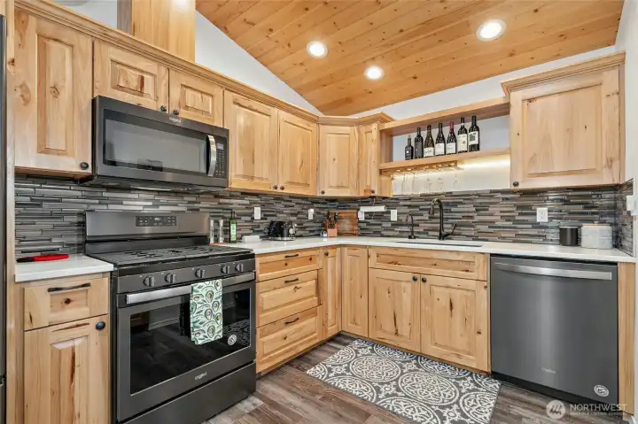 Absolutely gorgeous hickory cabinets and black stainless steel appliances and gas stove. Absolutely gorgeous hickory cabinets and black stainless steel appliances and gas stove.