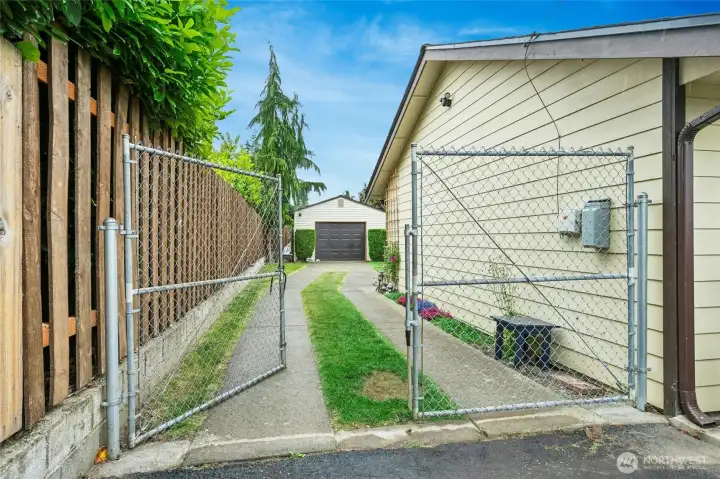 Newer wood fence and gated access to detached garage and potential RV parking. Newer wood fence and gated access to detached garage and potential RV parking.