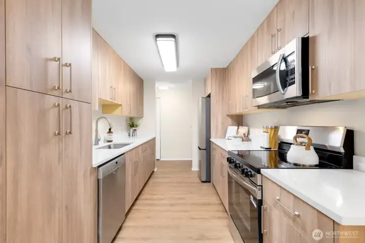 This stunning and well laid out galley cooks triangle kitchen features lux high quality vinyl plank flooring with cork underlayment, SS appliances, built in microwave, dishwasher, granite counters with heavy gauge undermount sink, and a fridge with an ice maker. Oh, and the pantry is sweet too. I love this remodel! This stunning and well laid out galley cooks triangle kitchen features lux high quality vinyl plank flooring with cork underlayment, SS appliances, built in microwave, dishwasher, granite counters with heavy gauge undermount sink, and a fridge with an ice maker. Oh, and the pantry is sweet too. I love this remodel!