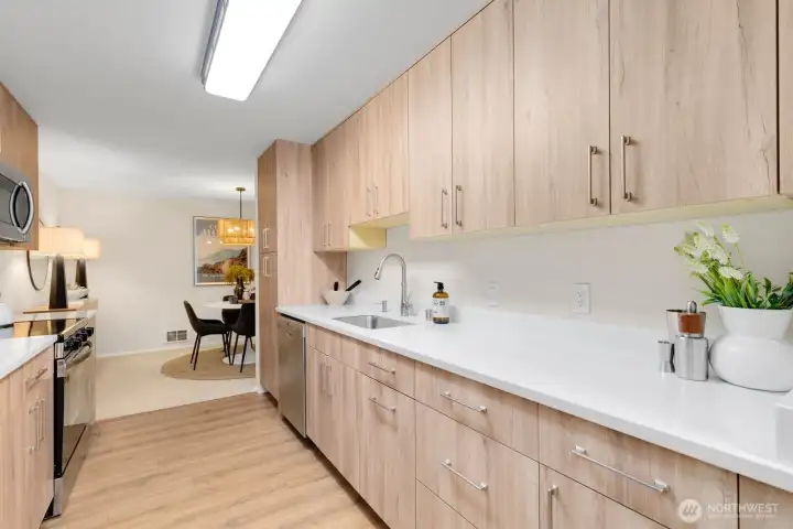 This stunning and well laid out galley cooks triangle kitchen features lux high quality vinyl plank flooring with cork underlayment, SS appliances, built in microwave, dishwasher, granite counters with heavy gauge undermount sink, and a fridge with an ice maker. Oh, and the pantry is sweet too. I love this remodel! This stunning and well laid out galley cooks triangle kitchen features lux high quality vinyl plank flooring with cork underlayment, SS appliances, built in microwave, dishwasher, granite counters with heavy gauge undermount sink, and a fridge with an ice maker. Oh, and the pantry is sweet too. I love this remodel!
