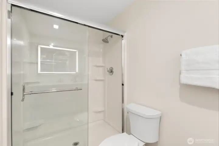 Primary bathroom full-width walk-in shower. Doors slide open from either side. Primary bathroom full-width walk-in shower. Doors slide open from either side.