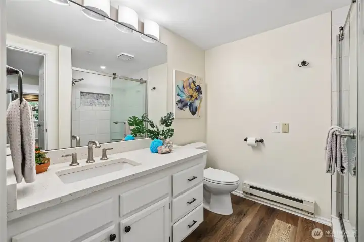 Primary bathroom with new light, counterstops are refreshed and plank flooring Primary bathroom with new light, counterstops are refreshed and plank flooring