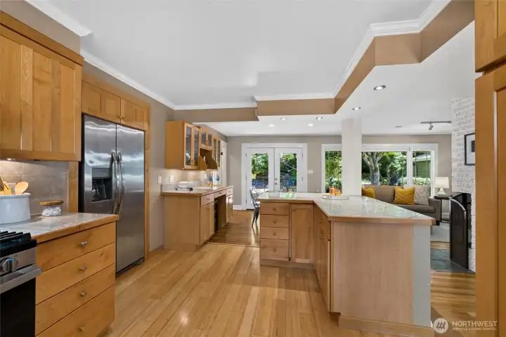 Warm wood cabinetry and rich hardwood floors create an inviting kitchen that's as beautiful as it is functional. Warm wood cabinetry and rich hardwood floors create an inviting kitchen that's as beautiful as it is functional.