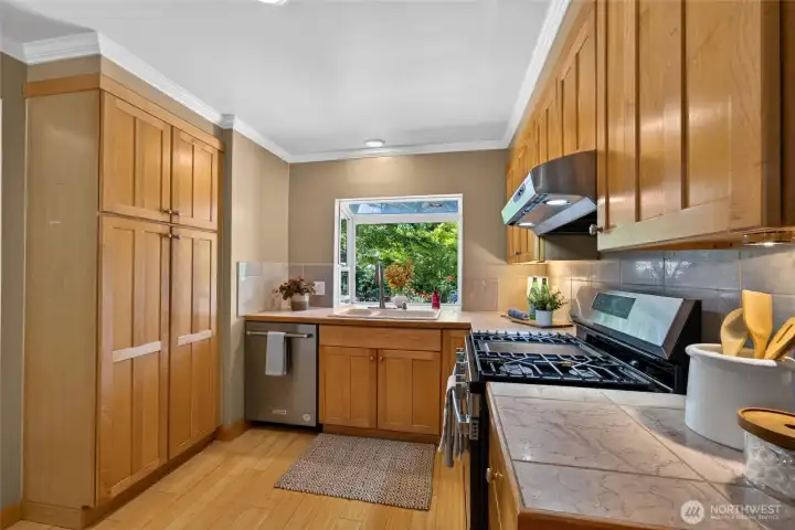 Natural light streams through the window above the sink, creating a bright and cheerful workspace. Natural light streams through the window above the sink, creating a bright and cheerful workspace.