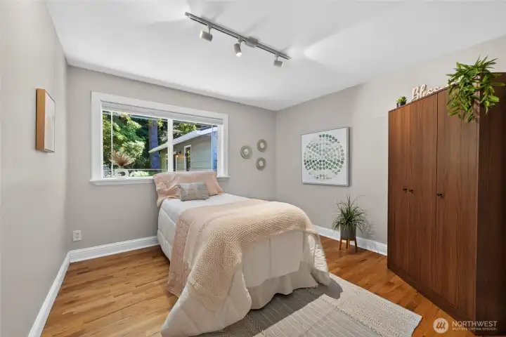 Abundant natural light pours through the large window, enhancing the room's warm and inviting feel. Abundant natural light pours through the large window, enhancing the room's warm and inviting feel.