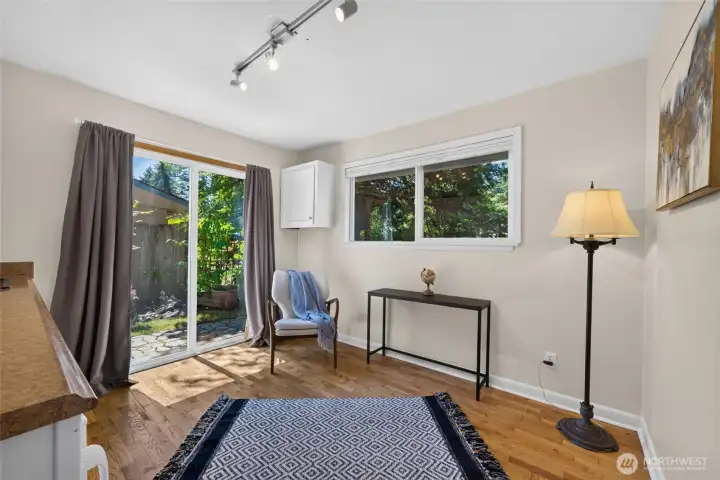 A sliding glass door provides private access to the peaceful backyard sanctuary, filling the room with natural light. A sliding glass door provides private access to the peaceful backyard sanctuary, filling the room with natural light.