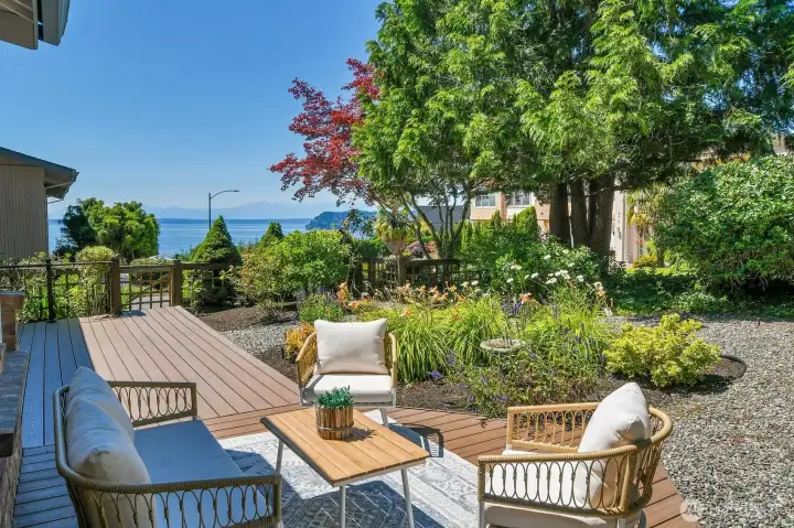 The deck is surrounded by mature landscaping and offers the perfect setting for outdoor living and entertaining.