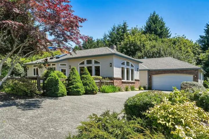 Beautifully maintained landscaping and timeless curb appeal welcome you home.