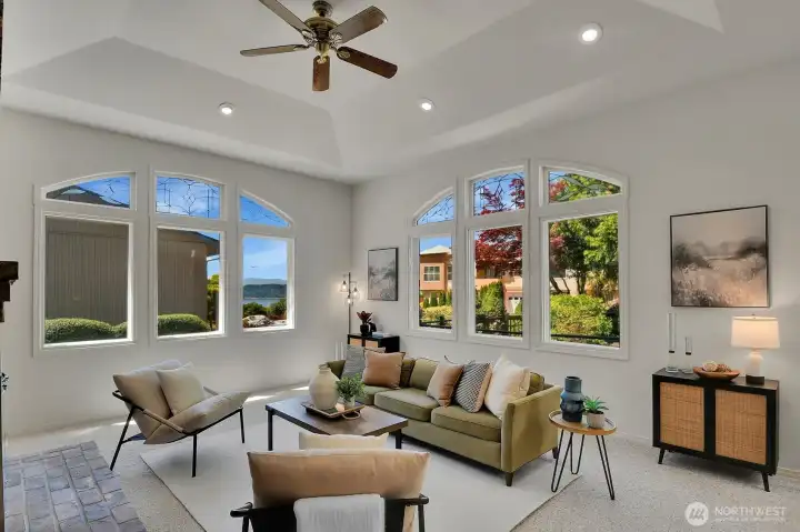 Soaring ceilings, oversized windows, and abundant natural light fill the spacious family room.
