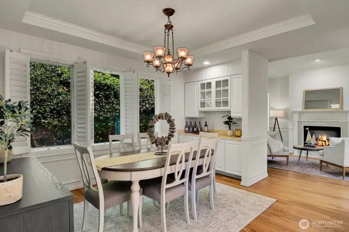 Plantation shutters, tray ceiling, and a built-in hutch create an ideal space for hosting holidays and celebrations, or just everyday meals in the generous formal dining room.